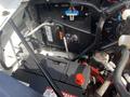 Close-up view of the battery and wiring in the engine compartment of a 2022 GMC Savana