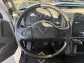 The interior of a 2017 International 4300 with a steering wheel featuring controls and a dashboard displaying various gauges and indicators