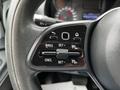 Close-up of the steering wheel controls of a 2020 Mercedes-Benz Sprinter featuring buttons for cruise control and settings