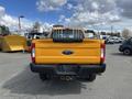 A yellow 2017 Ford F-250 Super Duty truck viewed from the rear with a visible tailgate and Ford logo