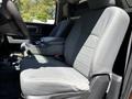 Interior of a 2015 RAM 5500 showing two gray cloth front seats and a central console between them