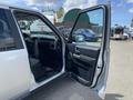 A 2006 Land Rover LR3 with an open front driver's door displaying the interior features and dashboard