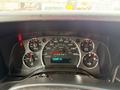 A close-up view of the dashboard of a 2020 Chevrolet Express showing the speedometer odometer and various instrument gauges