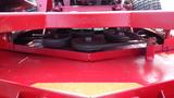 Close-up view of the cutting deck and pulleys of a 2014 Ferris Mower ISX 800 showcasing its red metal structure and mechanical components