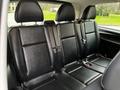 Interior view of the back seats of a 2018 Mercedes-Benz Metris featuring three empty black leather seats with seat belts