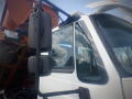A 2016 International WorkStar 7500 truck with a white cab and large side mirrors showcasing its reflective surface and modern design