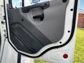 The interior door panel of a 2016 Freightliner M2 106 featuring a black handle and a textured gray surface