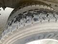 A close-up of a 2016 International 7400 tire showcasing its deep tread pattern designed for traction and durability