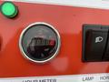 A digital hour meter displaying the number 2 on a red control panel with a green indicator light and a switch for lamps.