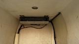 An air conditioning unit mounted inside the rear of a 2005 Chevrolet Express van