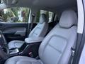 Interior view of a 2019 Chevrolet Colorado showing two leather front seats and a center console with armrest