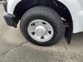 Close-up of a silver wheel and tire from a 2010 Ford F-250 SD with a rugged tread pattern and visible valve stem