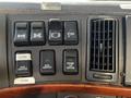 The dashboard of a 2005 Volvo VND 122 featuring various control switches including engine air control and auxiliary switches