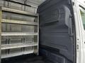 A 2020 Mercedes-Benz Sprinter with open cargo space featuring metal shelving units on one side