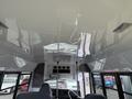 Interior view of a 2013 Chevrolet Express showing the ceiling and front dashboard area with seats visible