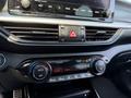Interior view of a 2024 Kia Forte5 displaying the climate control panel with temperature settings and control dials