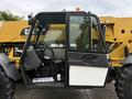 A 2014 Caterpillar TL1055C telehandler with an open door displaying the driver's seat and controls inside the cabin