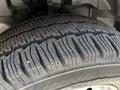 A close-up of a heavily treaded tire from a 2023 Ford Transit showing deep grooves and a rugged texture designed for traction