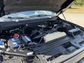 A 2015 Ford F-150 engine compartment displaying the engine components battery and fluid reservoir