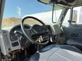 Interior cabin of a 2009 International 7500 showing the steering wheel dashboard controls and gear shifter