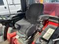 A black upholstered seat of a Toro Groundmaster 5910 equipped with controls and a lever on the side
