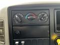 Dashboard controls of a 2019 International 4300 featuring dials for fan speed temperature and air direction with various buttons for vehicle climate settings