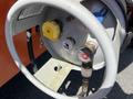 Close-up of a pressure gauge and valves on a 2008 JLG Boom Lift showing a yellow valve handle and rubberized pressure indicator with markings