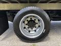 A close-up of a 2020 Chevrolet Silverado tire showcasing a shiny chrome wheel rim and a black tire with deep treads