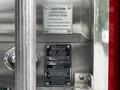 A close-up of a metal panel featuring caution instructions and a warning label for a 1991 Sutphen Deluge fire truck's ladder rack system
