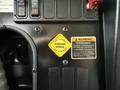 A yellow parking brake lever labeled 'PULL TO APPLY PUSH TO RELEASE' located on the dashboard of a 2016 International CE300 bus