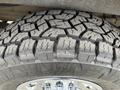 Close-up of a textured tire tread on a wheel of a 2012 GMC Savana showing deep grooves and rugged design for enhanced traction