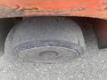 A worn and cracked tire of a 2010 Toyota 7FGGU25 forklift close-up showing the tread and rim details