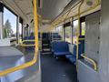Interior of a 2016 Grande West Vicinity bus featuring blue fabric seats and yellow handrails with an open seating area