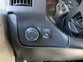 Dashboard controls of a 2019 Chevrolet Express featuring a dial for headlights and a button for fog lights