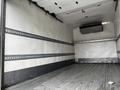 A 2018 Isuzu NRR truck with an empty cargo area featuring a clean gray floor and smooth walls