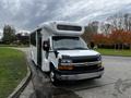 A white 2017 Chevrolet Express bus with a front passenger door and wheelchair access features