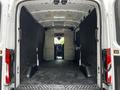 A 2022 Ford Transit cargo van with an empty interior featuring a flat floor and tall side walls showcasing ample storage space