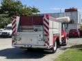 A red 1991 International 4600 fire truck with a silver rear compartment featuring reflective stripes and lights