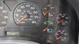 The dashboard of a 2005 International 7400 featuring speedometer fuel gauge voltmeter and air pressure gauges