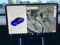 A digital display shows a blue 2019 Tesla Model 3 alongside a map with a red location marker and navigation details on the screen