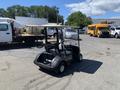 A 2019 Yamaha G29 E Electric golf cart with a gray body and beige seats visible from the rear in a parking area