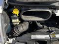 A close-up view of the engine compartment of a 2017 RAM Promaster showing the air intake and coolant reservoir with a yellow cap