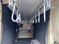 Interior view of a 2015 Ford F-550 with metal hooks mounted on a flat surface and carpeted sides