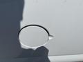 A fuel filler cap on a white 2012 Chevrolet Express van