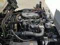 A close-up view of the engine compartment of a 2007 GMC W3500 showing various mechanical components and hoses