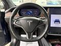 Interior view of a 2020 Tesla Model X showcasing the steering wheel and central touchscreen display with the vehicle's interface visible