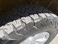 Close-up of a rugged tire tread on a silver wheel from a 2015 RAM 1500 showcasing deep grooves and aggressive pattern suitable for off-road conditions