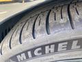 Close-up of a Michelin tire with visible tread patterns and markings on the sidewall showcasing wear and branding