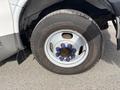 Close-up of a tire mounted on a 2018 Chevrolet Express with blue lug bolts and a visible tread pattern