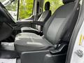 Interior view of a 2022 Ford Transit showing a driver's seat with gray upholstery and adjustable features